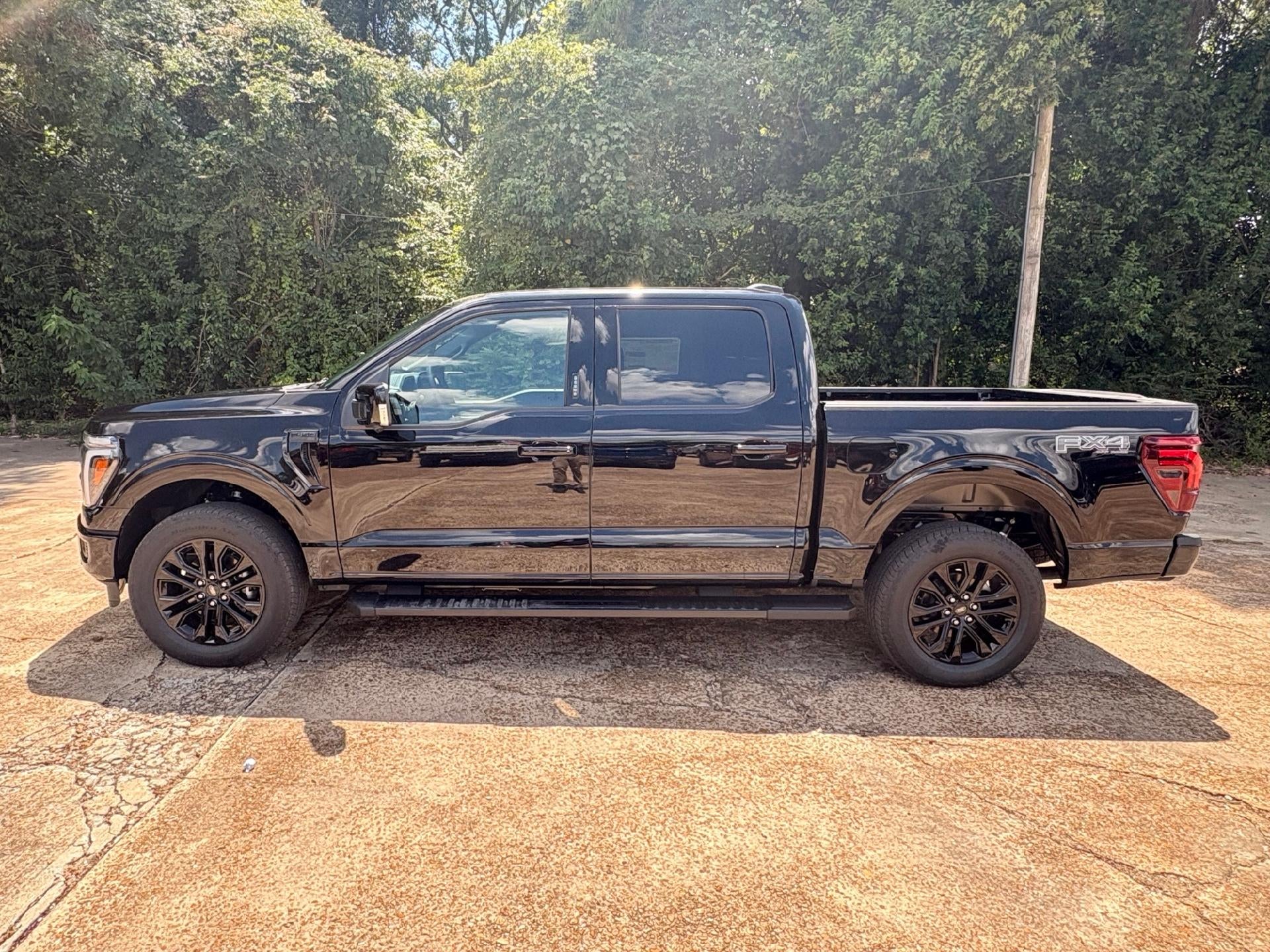 2026 Ford F-150 Lariat in Agate Black Metallic — front three-quarter view