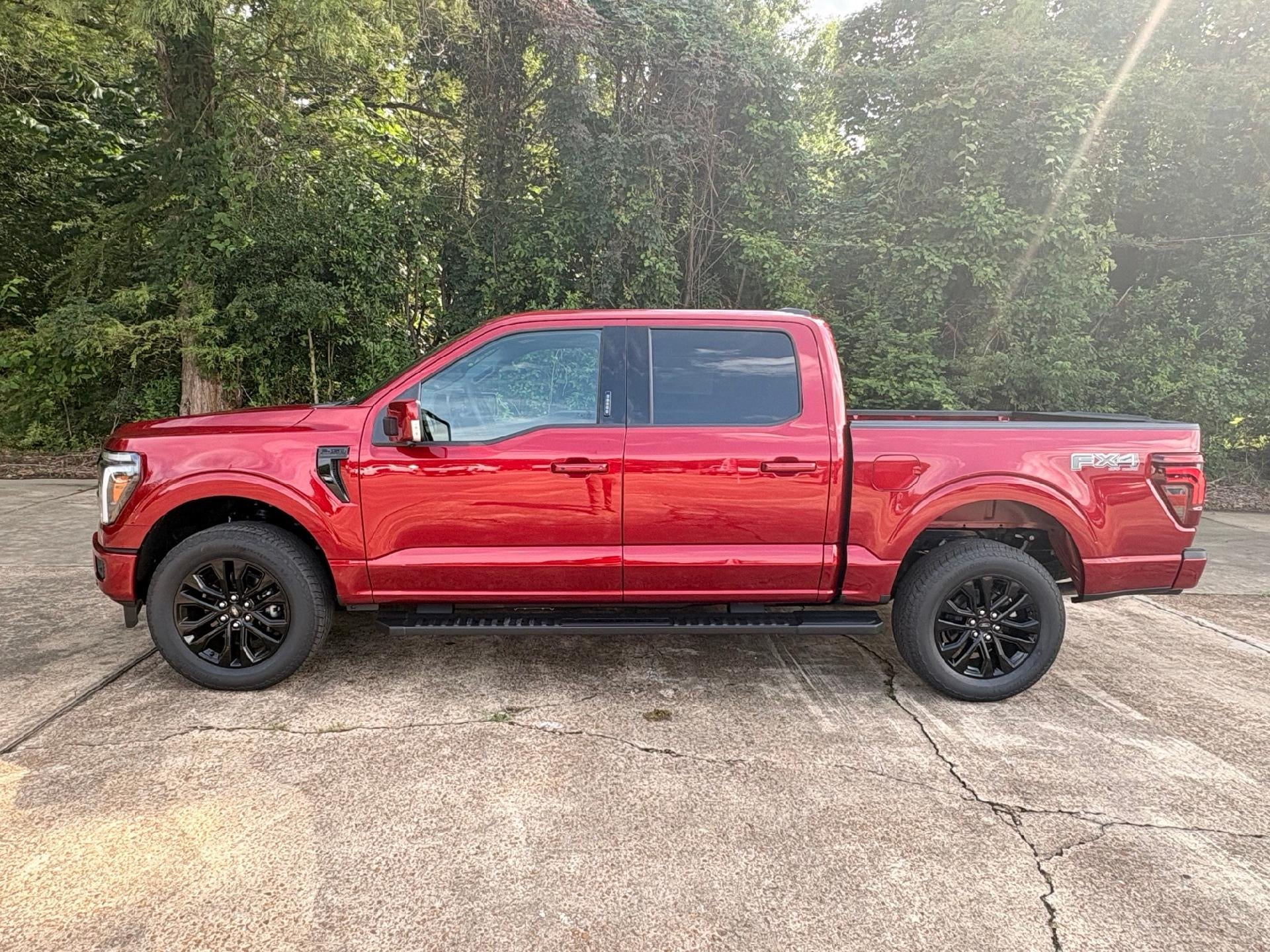 2026 Ford F-150 Lariat in Ruby Red Metallic Tinted Clearcoat — front three-quarter view